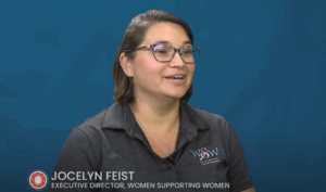 a woman wearing glasses is sitting down