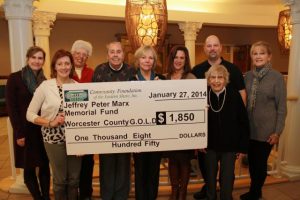 10 people holding a giant check to Worcester County Gold MD