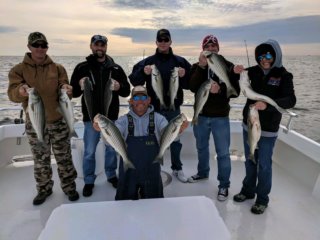 fishermen holding rockfish