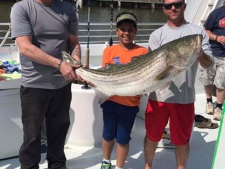 three guys holding a giant fish